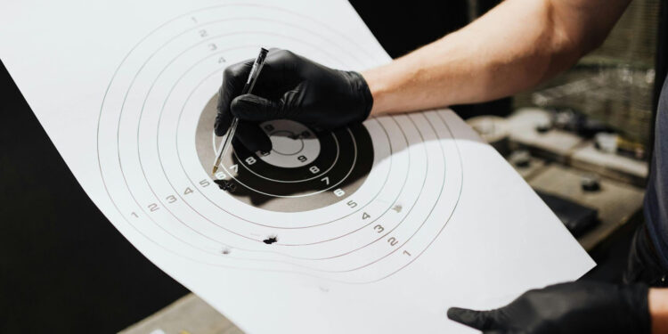 Person holding a paper target.